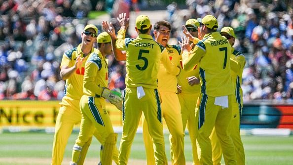 Australia's Xavier Bartlett (C) celebrates taking the wicket of India's Virat Kohli