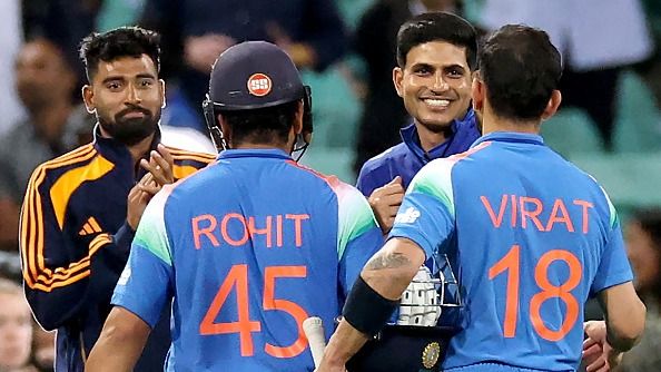 India's Rohit Sharma and Virat Kohli are congratulated by India's captain Shubman Gill (2R)
