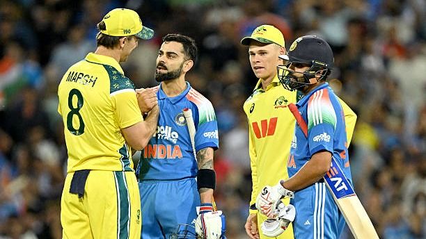 India's Virat Kohli (2L) shakes hands with Australia's captain Mitchell Marsh (L)