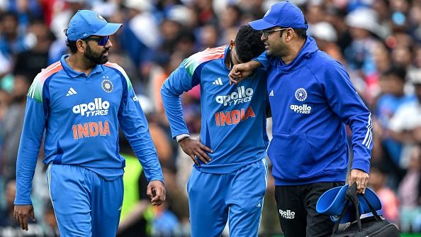India's Shreyas Iyer (C) reacts in pain