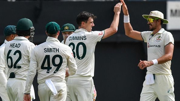 Pat Cummins (2nd R) and Mitchell Starc (R) of Australia celebrate