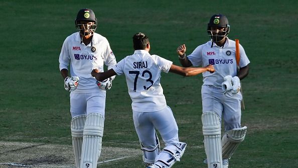 Mohammed Siraj of India runs to the field to celebrate with Rishabh Pant and Navdeep Saini