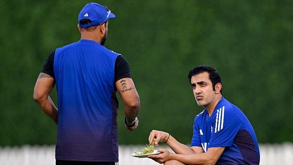 India's head coach Gautam Gambhir (R) speaks with a team official during a practice session