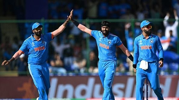 Hardik Pandya (C) celebrates with teammates Jasprit Bumrah (L) and Virat Kohli after taking the wicket 