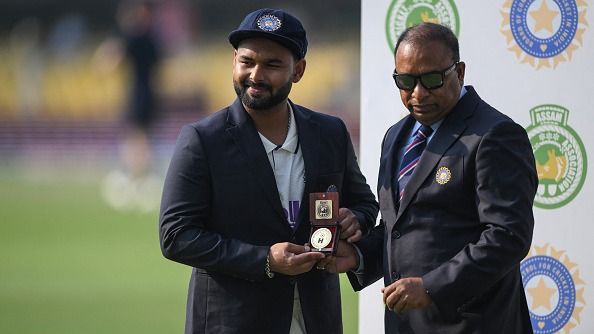 India's captain Rishabh Pant (L) receives a memento from Devajit Saikia