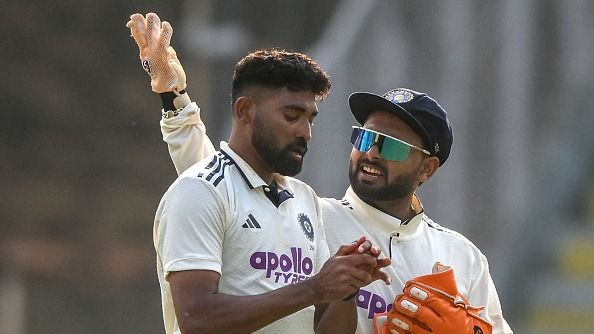 India's captain Rishabh Pant (R) speaks with his teammate Mohammed Siraj