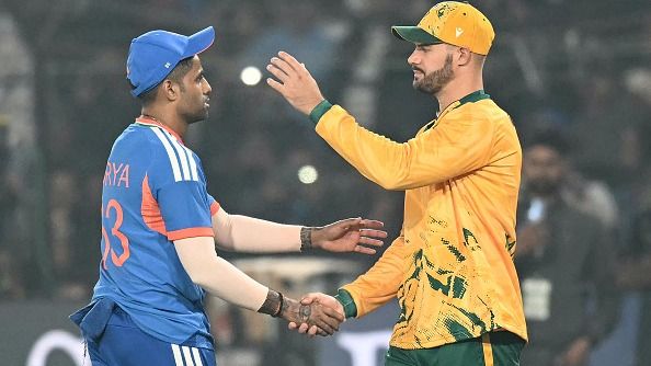 India's captain Suryakumar Yadav (L) is congratulated by his South African counterpart Aiden Markram