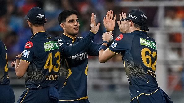 Gujarat Titans' Gerald Coetzee (R) celebrates with captain Shubman Gill (C)