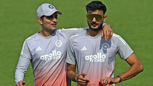 India's captain Shubman Gill (L) and teammate Axar Patel interact during a practice session
