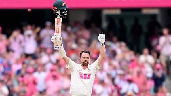 Travis Head of Australia raises the bat to celebrate