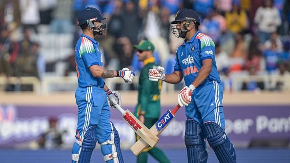 India's Virat Kohli (L) and Rohit Sharma bump their fists