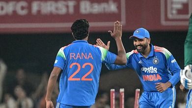 India's Harshit Rana (L) celebrates with teammate Rohit Sharma (C)