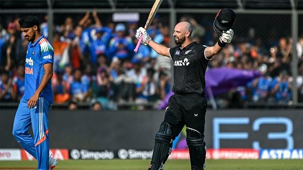 New Zealand's Daryl Mitchell (R) celebrates after scoring a century (100 runs)