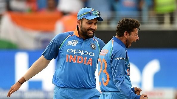 Indian cricket team captain Rohit Sharma (L) celebrates with teammate Kuldeep Yadav (L)