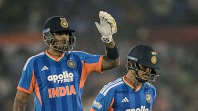 India's captain Suryakumar Yadav (L) pats teammate Ishan Kishan 