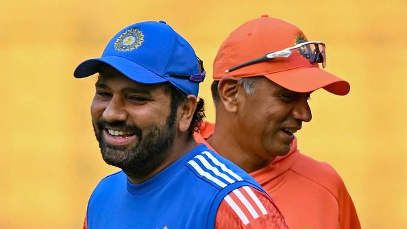 India's captain Rohit Sharma and head coach Rahul Dravid (R) laugh during a practice session