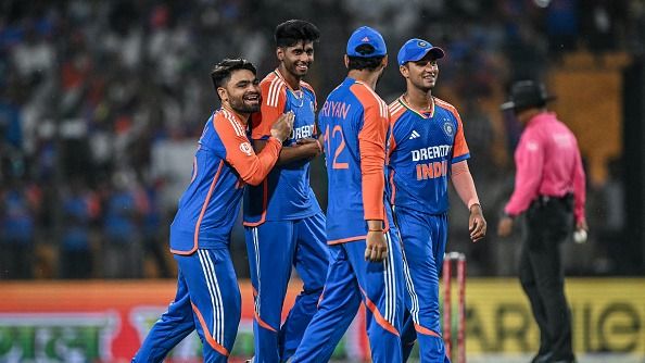 India's Mayank Yadav (2L) celebrates with teammates