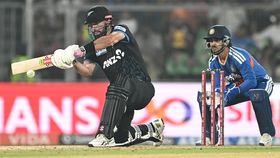New Zealand's Daryl Mitchell (R) plays a shot as India's wicketkeeper Ishan Kishan watches New Zealand's Daryl Mitchell (R) plays a shot as India's wicketkeeper Ishan Kishan watches