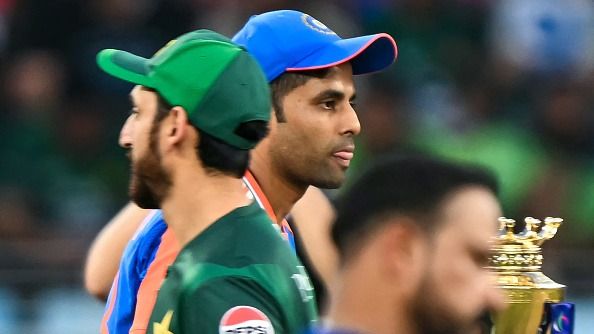 India captain Suryakumar Yadav (C-back) walks past his Pakistani counterpart Salman Agha 