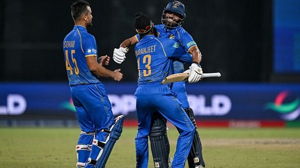UAE's Aryansh Sharma (R) celebrates 