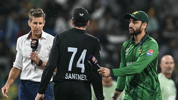 Pakistan's captain Salman Agha (R) shakes hands with New Zealand's captain Mitchell Santner (C)