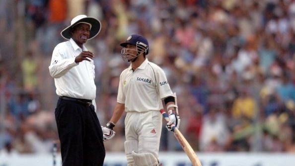 Indian cricketer Sachin Tendulkar (R) speaks with umpire Steve Bucknor