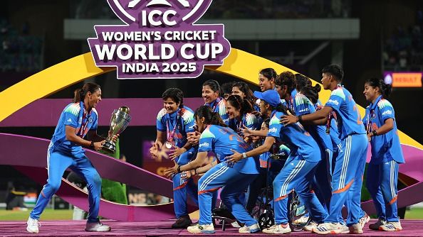 Harmanpreet Kaur of India prepares to lift the ICC Women's Cricket World Cup trophy after her team's victory