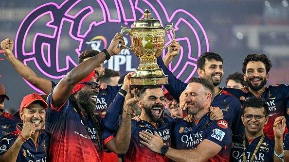 Royal Challengers Bengaluru's Virat Kohli (C), along with his former teammates AB de Villiers (centre R) and Chris Gayle (centre L), celebrates with the trophy after winning the Indian Premier League (IPL) Twenty20