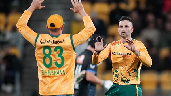 South Africa captain Keshav Maharaj (R) celebrates bowling New Zealand's Cole McConchie