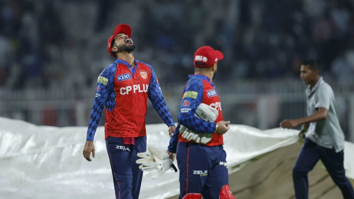 Shreyas Iyer looks at the sky during the rain