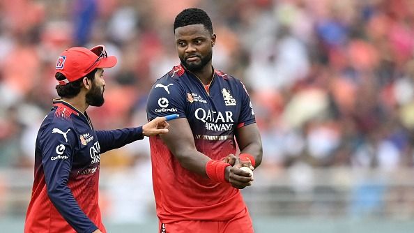 Royal Challengers Bengaluru's Romario Shepherd (R) listens to his team captain Rajat Patidar during the Indian Premier League (IPL) Twenty20 cricket match between Punjab Kings and Royal Challengers Bengaluru