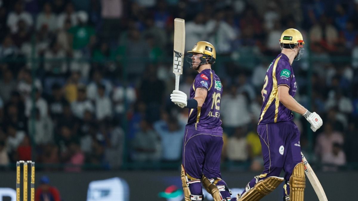 Finn Allen raises his bat after scoring a century