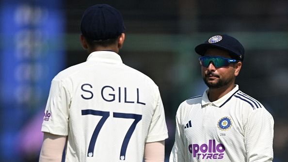 India's Kuldeep Yadav (R) speaks with his captain Shubman Gill 