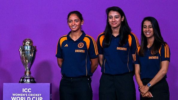 Indian team players Jemimah Rodrigues (R), Smriti Mandhana (C) and Harmanpreet Kaur pose with the trophy during an event held to mark 50 days countdown to the 2025 ICC Women's Cricket World Cup in Mumbai on August 11, 2025.