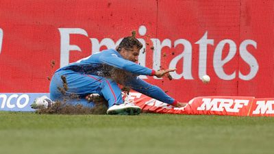 'We're lucky Mujeeb hasn't got a serious knee injury': Afghanistan coach unhappy with poor state of Dharamsala outfield Mujeeb Ur Rahman dives during clash against Bangladesh (Getty Images)