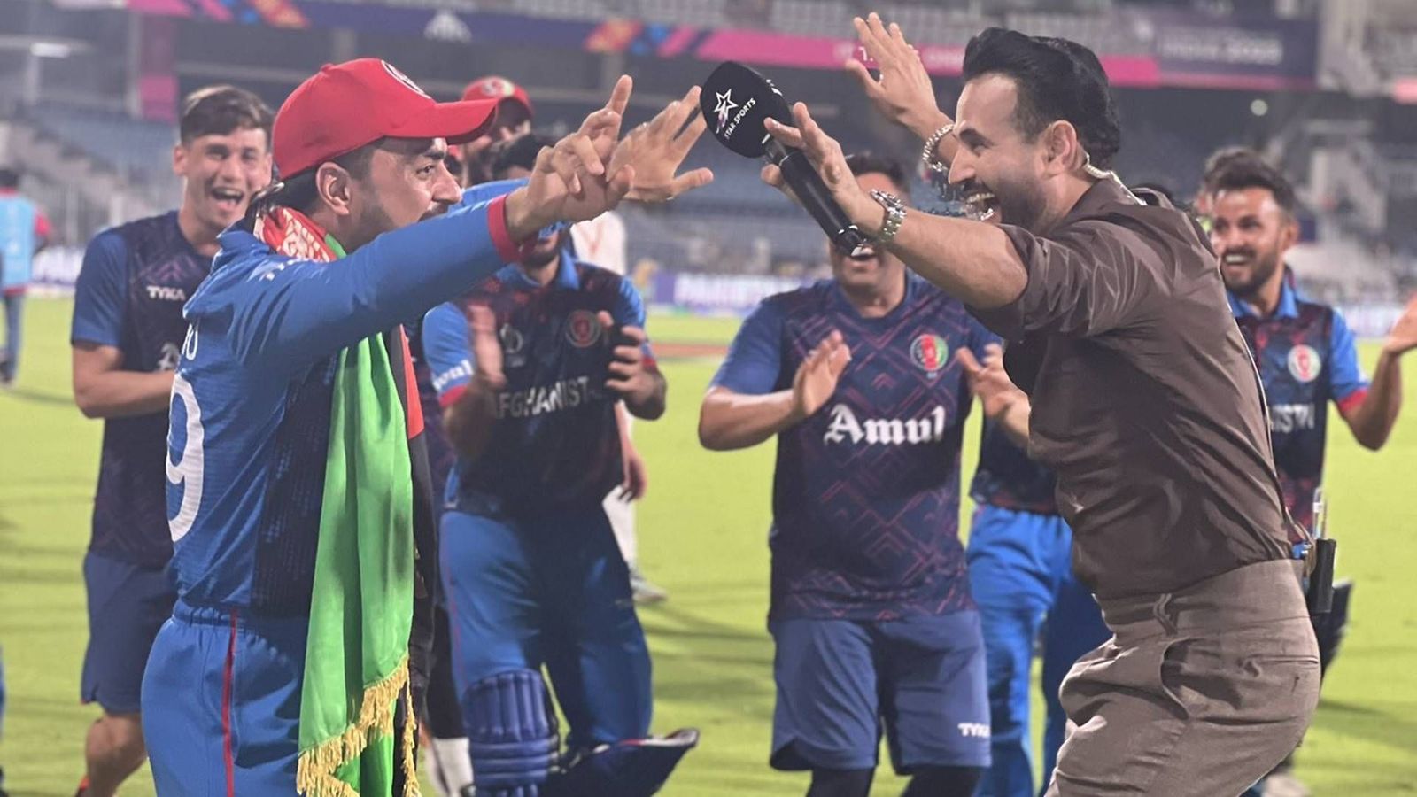 Rashid Khan halts 'lap of honour' midway to dance with Irfan Pathan after historic win over Pakistan, watch viral video Rashid Khan and Irfan Pathan dance after Afghanistan's win over Pakistan (Screengrab: Irfan Pathan/X)