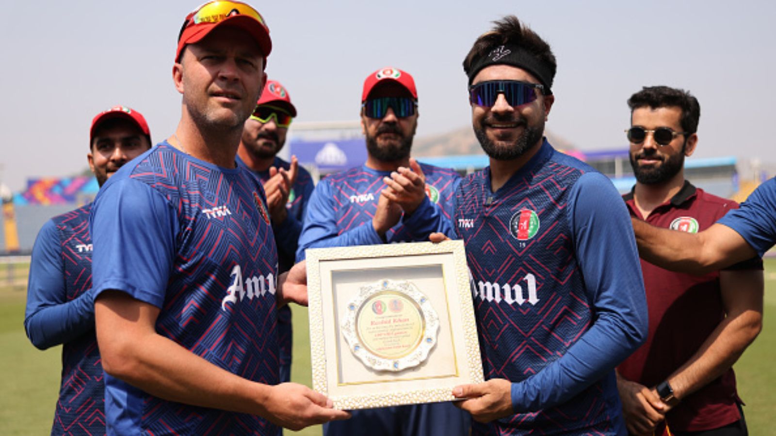 'Nobody's got 100 yet, so...': Afghanistan coach Jonathan Trott plays down batting unit's performance despite another win Afghanistan's Rashid Khan presented with a memento by head coach Jonathan Trott.