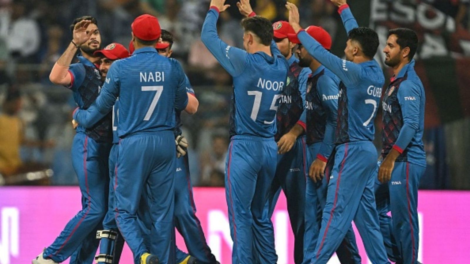 Star Afghanistan cricketer retires from ODIs at age 24 after team bows out of World Cup Afghanistan's Naveen-ul-Haq (L) celebrates with teammates after taking the wicket of Australia's Travis Head during the 2023 ICC Men's Cricket World Cup one-day international (ODI) match between Australia and Afghanistan at the Wankhede Stadium in Mumbai