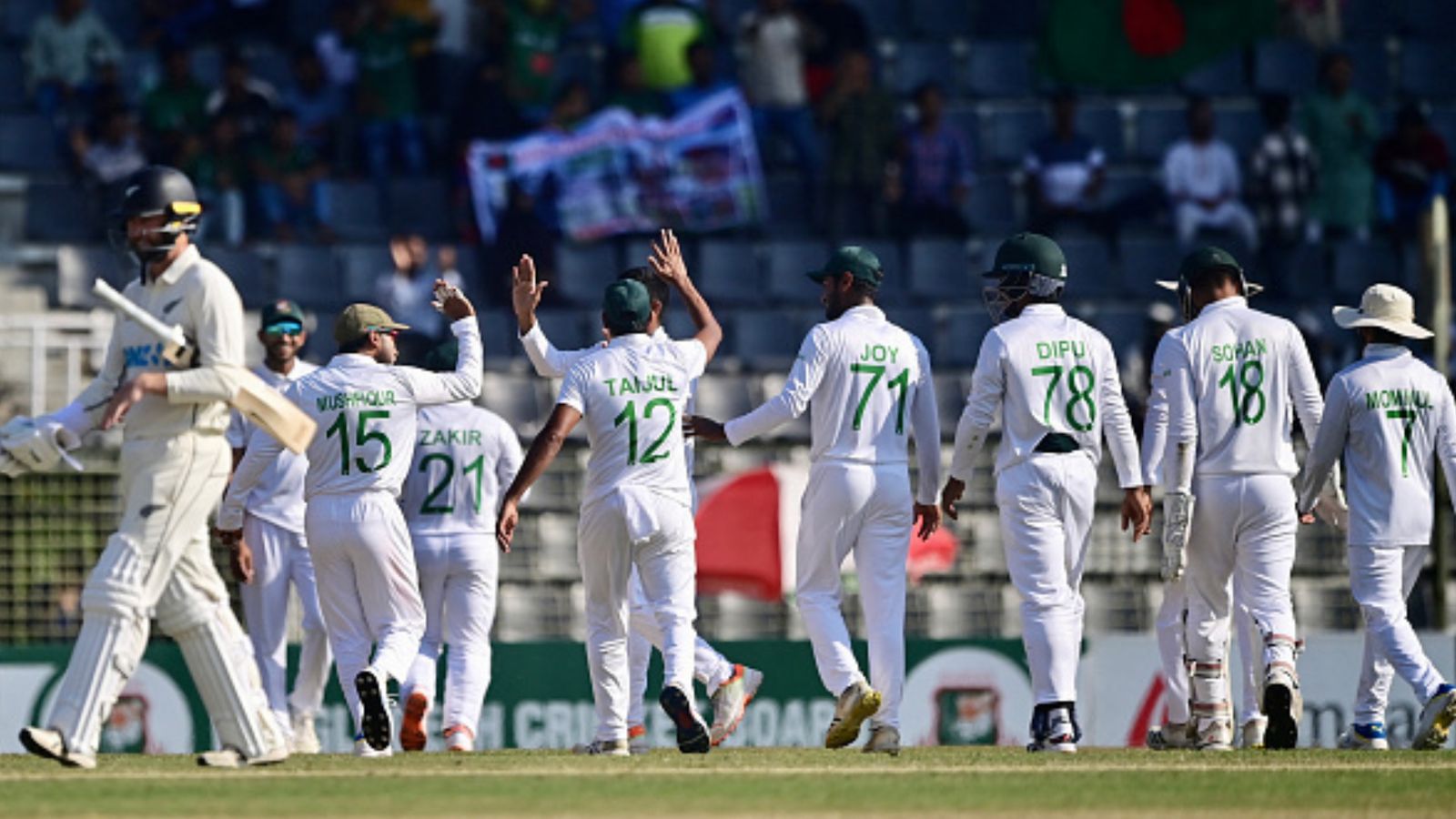 BAN vs NZ: Taijul Islam's spin wizardry puts New Zealand under the pump on Day 4, Bangladesh on cusp of historic win Bangladesh's cricketers celebrate the wicket of Henry Nicholls on 4th Day of the 1st Test against New Zealand in Sylhet on December 1, 2023. (Getty)