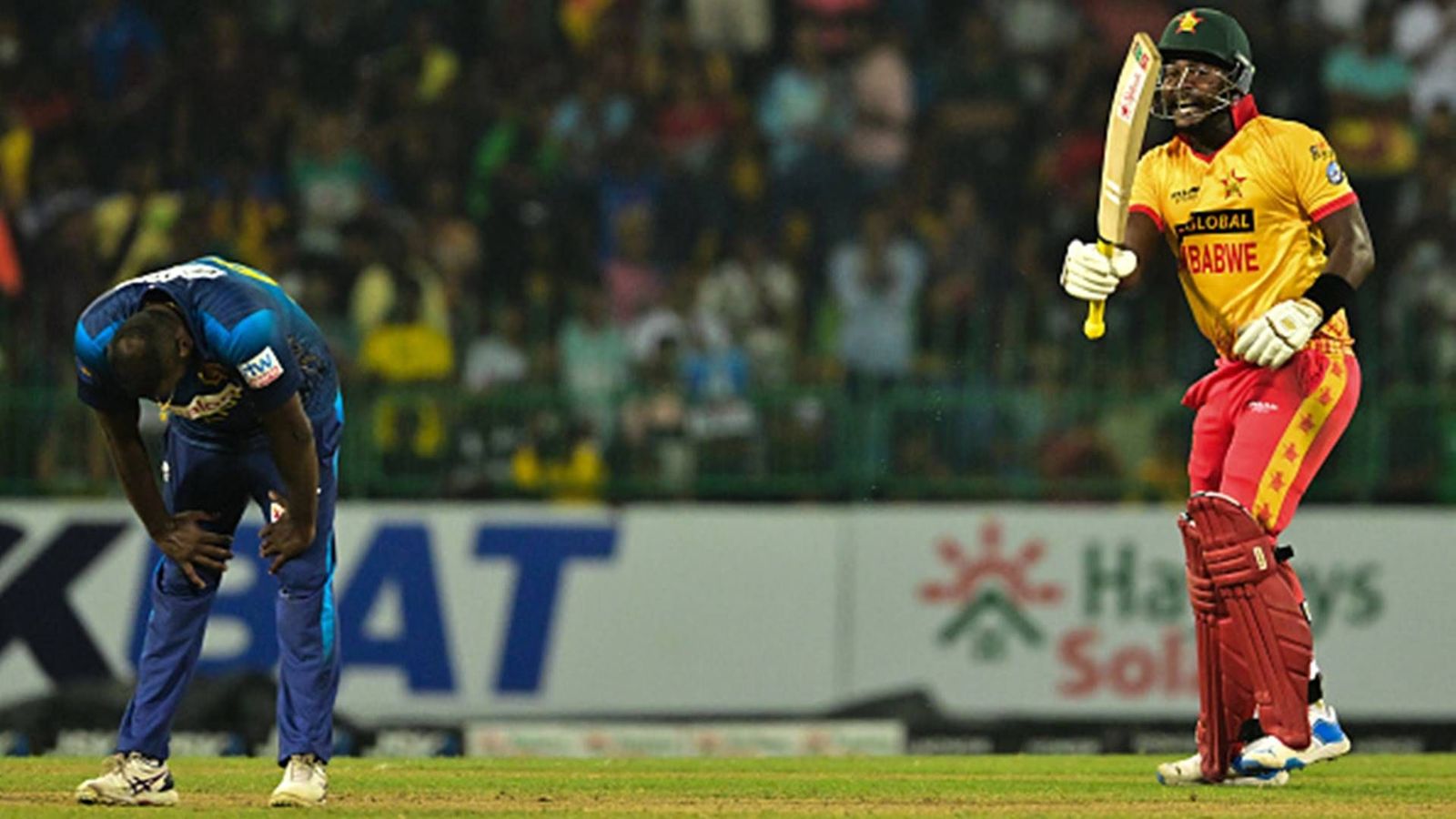 Zimbabwe register first-ever T20I win against Sri Lanka as Angelo Mathews gets tonked for 24 runs in final over of thrilling run chase Zimbabwe's Clive Madande celebrates after a six off Sri Lanka's Angelo Mathews (Getty Images)