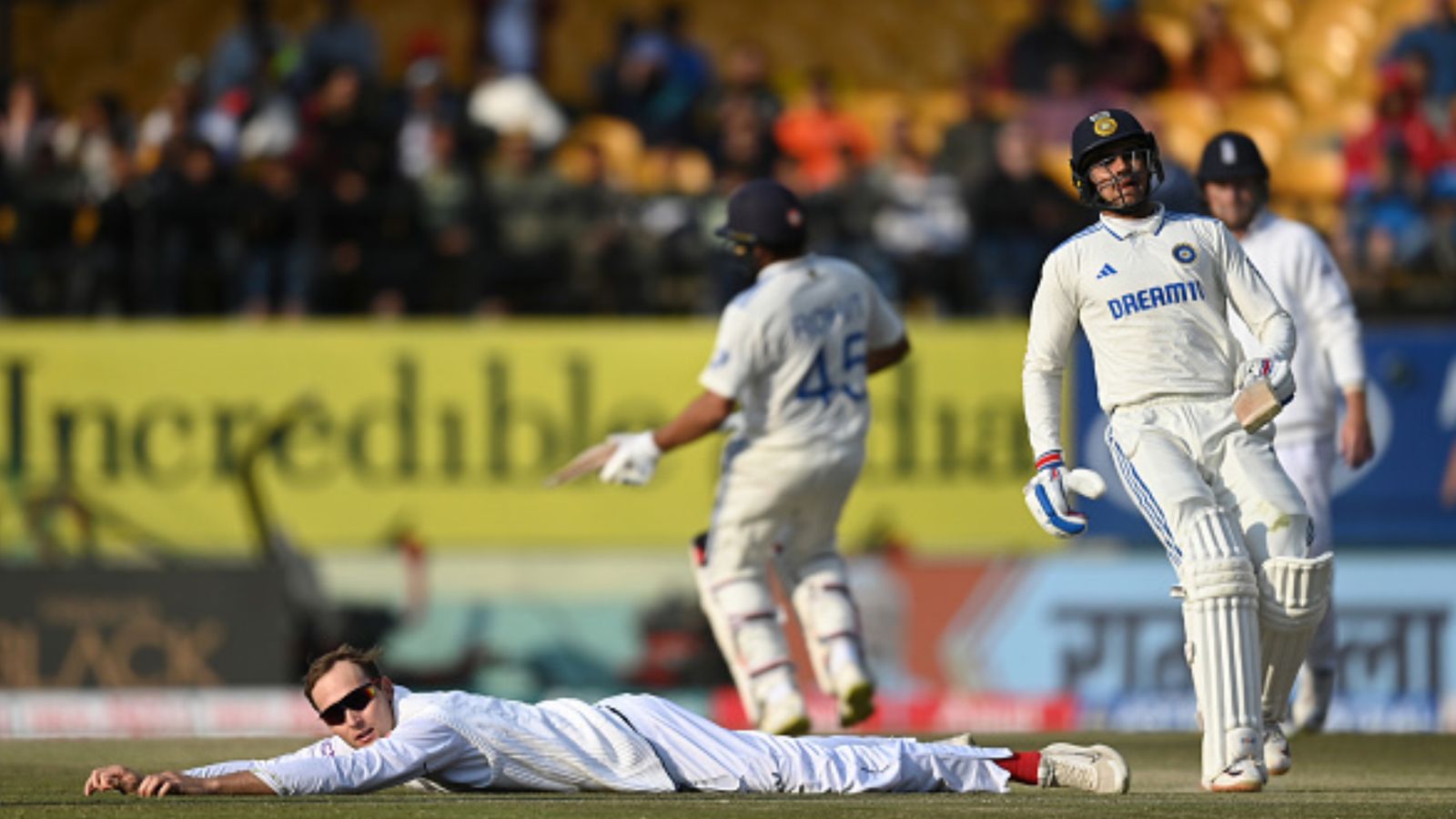 IND vs ENG: Rohit Sharma, Shubman Gill's incredible hundreds power India to dominant 255-run lead as England stare at defeat in Dharamsala England bowler Tom Hartley lies on the ground as Shubman Gill and Rohit Sharma score runs during Day 2 of the 5th Test on March 8. (Getty)