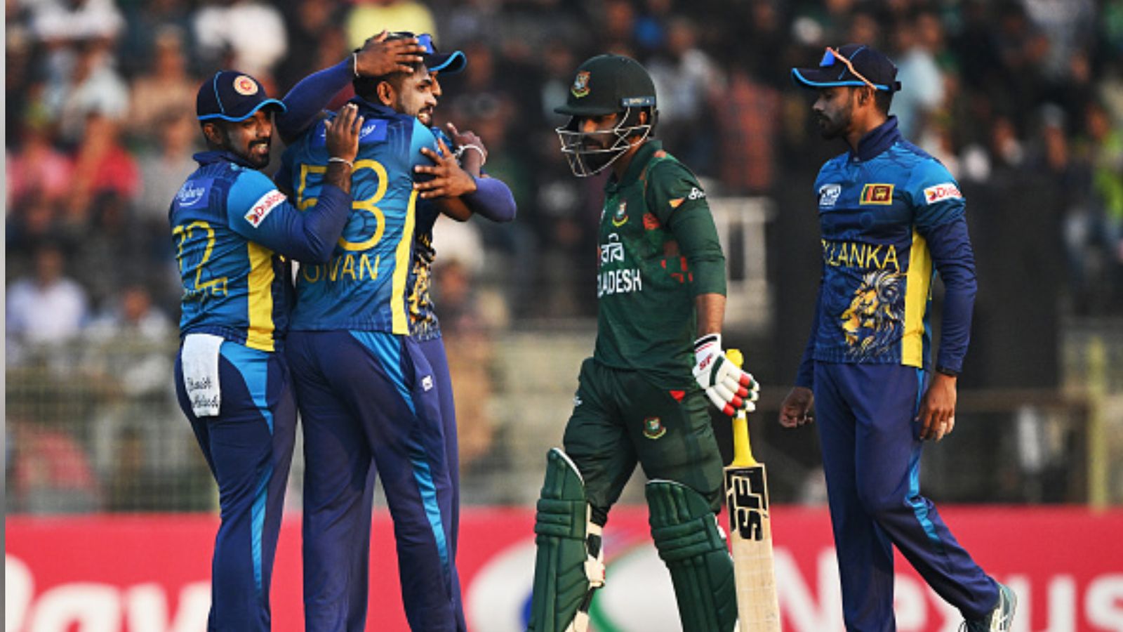 BAN vs SL: MI's Rs 4.8 crore signee runs riot with exceptional hat-trick to help Sri Lanka down Bangladesh in 3rd T20I, clinch series Sri Lanka's Nuwan Thushara (2L) celebrates with teammates after the dismissal of Bangladesh's Towhid Hridoy (2R) during the 3rd T20I in Sylhet on March 9. (Getty)