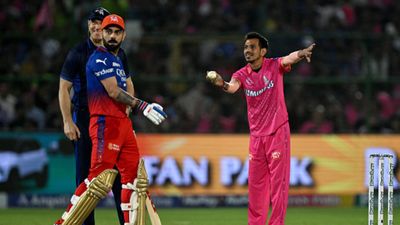 'When 200-plus was possible...': Rajasthan Royals troll Virat Kohli after his slowest IPL hundred fails to secure win for RCB Rajasthan Royals' Yuzvendra Chahal (R) gestures as Royal Challengers Bengaluru's Virat Kohli (C) looks on during their IPL 2024 match on April 6. (Getty)