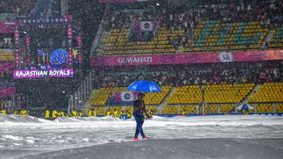 IPL 2024: Rain denies Sanju Samson's men top 2 finish as RR versus KKR clash gets abandoned due to unrelenting rain in Guwahati A field umpire walks across the ground amid rainfall as it delays the start of the IPL 2024 clash between RR and KKR on May 19. (Getty)