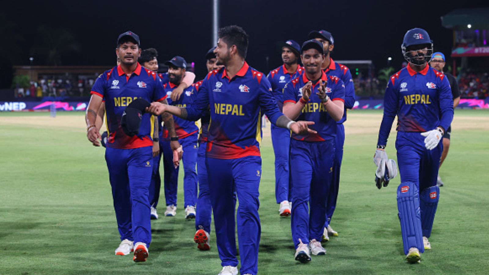 23-yr-old star becomes second fastest bowler to snare 100 T20I wickets after Nepal's T20 World Cup exit following loss vs Bangladesh Nepal's Sandeep Lamichhane walks off the field with teammates after the first innings during their T20 World Cup clash against Bangladesh on June 17. (Getty)