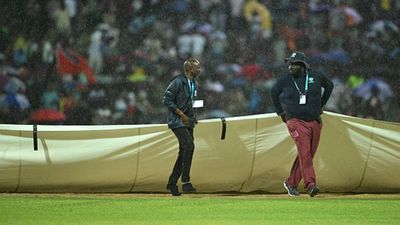 Strong showers interrupt West Indies' must-win game against South Africa, who will enter the semifinal if game gets washed out? Rain covers are deployed on the field after a sudden downpour during the Super 8 match between West Indies and South Africa in Antigua (Getty Images)