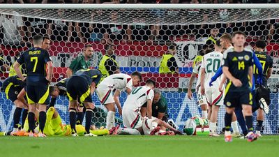 Euro 2024: Hungary forward Barnabas Varga in stable condition after breaking several bones in nasty collision Players receive medical attention following a collision between Scotland goalkeeper Angus Gunn and Hungary's Barnabas Varga (Getty Images)