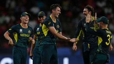 'Australia will win T20 World Cup if...': Usman Khawaja sets records straight but applies conditions for Mitchell Marsh-led team's title triumph Australia's Pat Cummins celebrates with teammates after dismissing Gulbadin Naib of Afghanistan (not pictured) during their T20 World Cup clash on June 22. (Getty)
