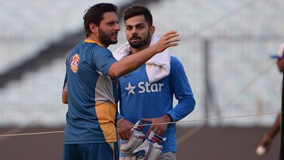 'Hume dhamkiya bhi milti rahi fir bhi hum India ke tour karte rahe': Shahid Afridi lashes out at BCCI for not agreeing to play Champions Trophy 2025 in Pakistan Shahid Afridi with Virat Kohli during a net session in T20 World Cup 2016 (File Photo: Getty Images)