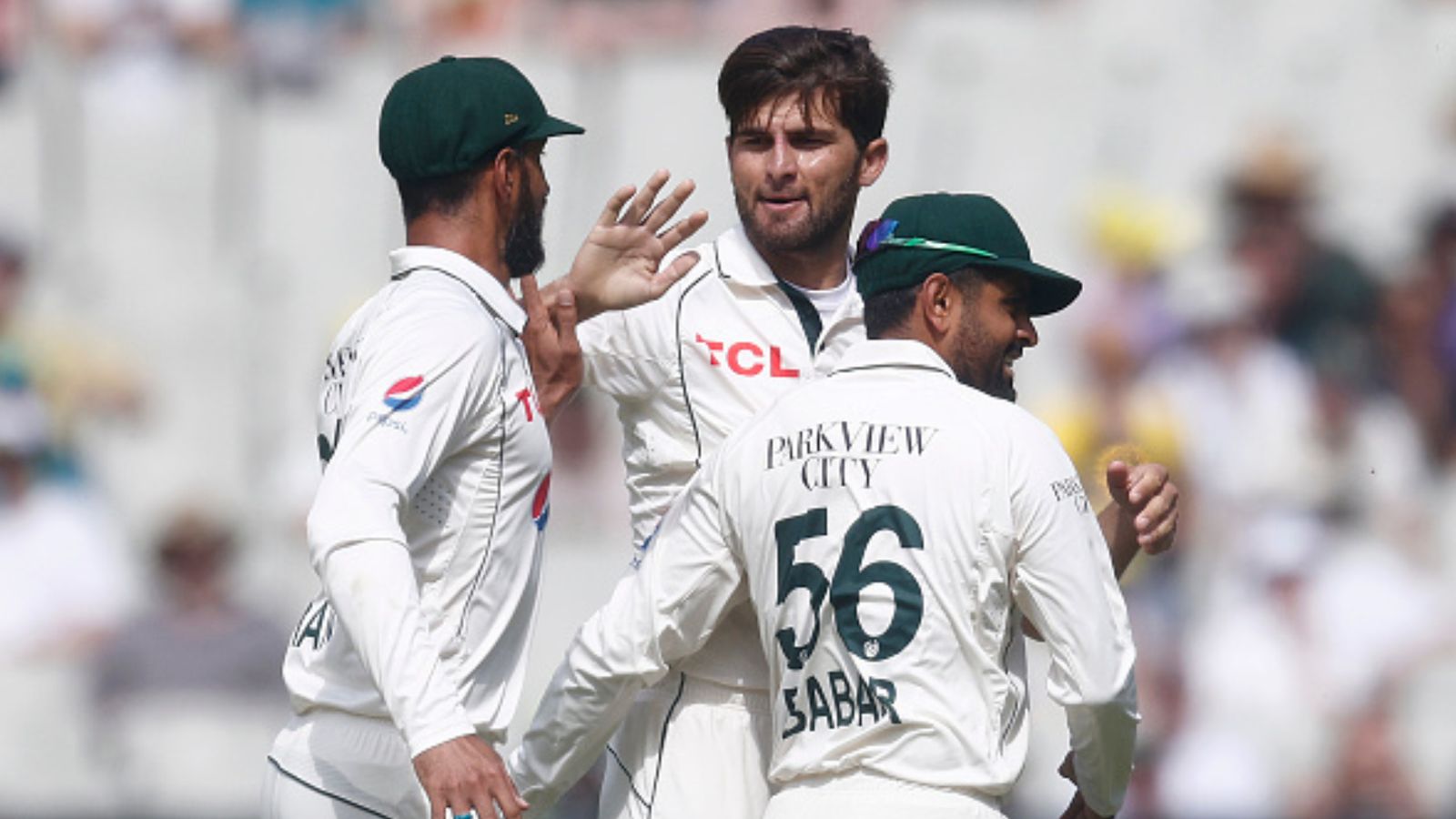 PCB appoints former Australia head coach as Pakistan's high-performance coach in Tests ahead of series against Bangladesh Pakistan's Shaheen Shah Afridi (centre) celebrates with Babar Azam (R) and Shan Masood after dismissing Travis Head of Australia a Test match against Australia on December 27, 2023 in Melbourne. (Getty)